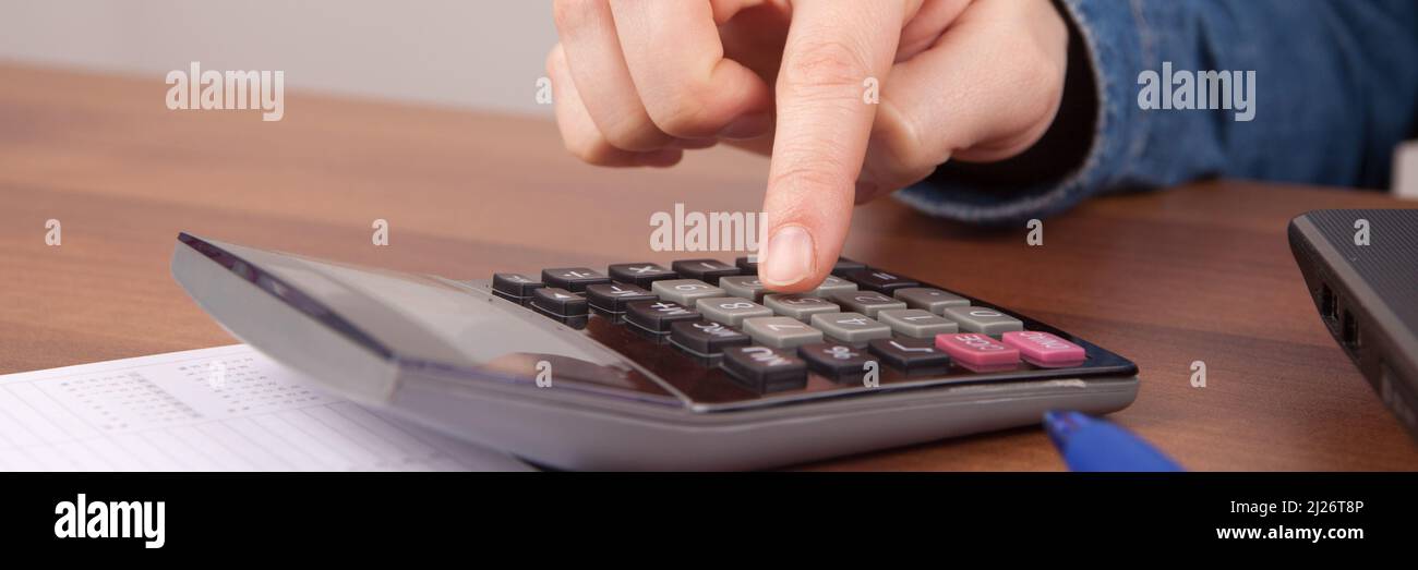 A person calculating some numbers with a calculator Stock Photo Alamy