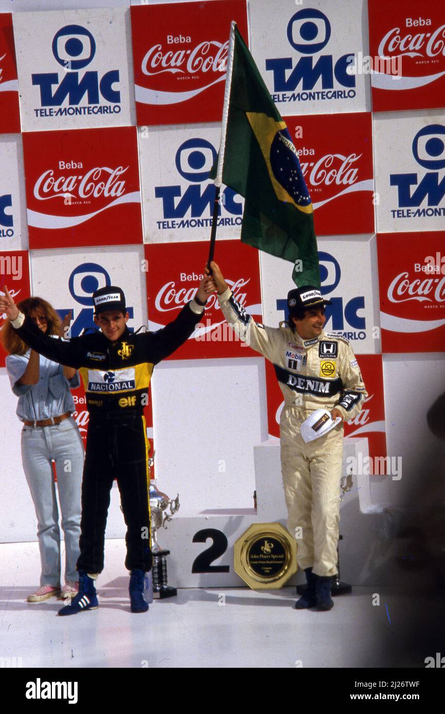 Ayrton Senna da Silva (BRA) Lotus 98T Renault 2nd position and Nelson Piquet (BRA) Williams Honda 1st position celebrates podium Stock Photo