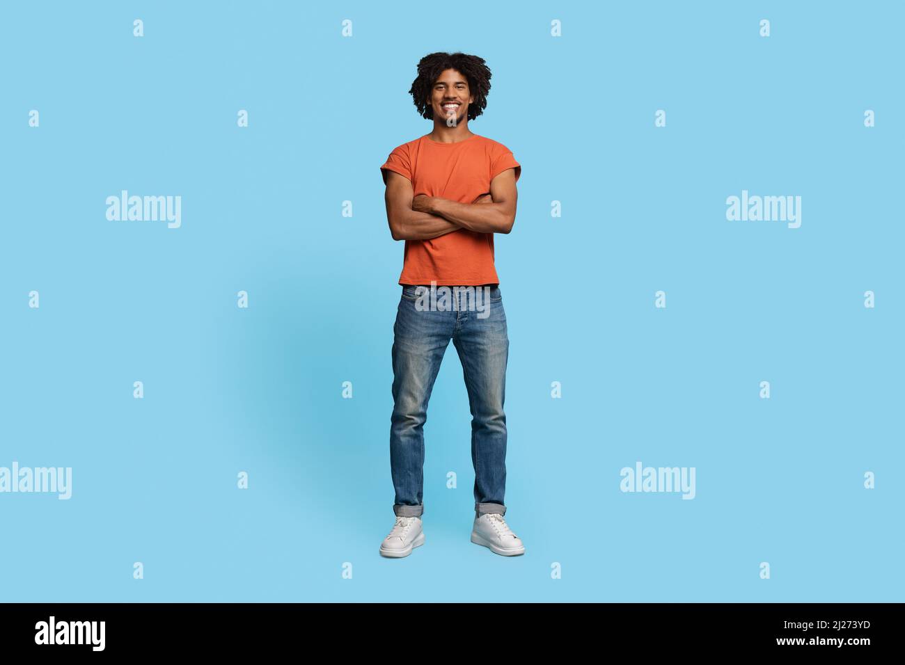 Confident stylish african american guy posing on blue Stock Photo