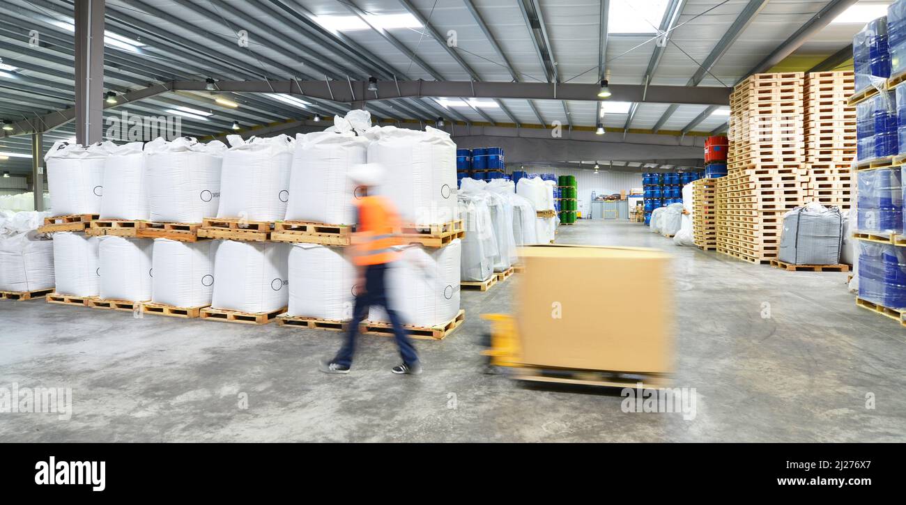 group of workers in the logistics industry work in a warehouse with chemicals Stock Photo