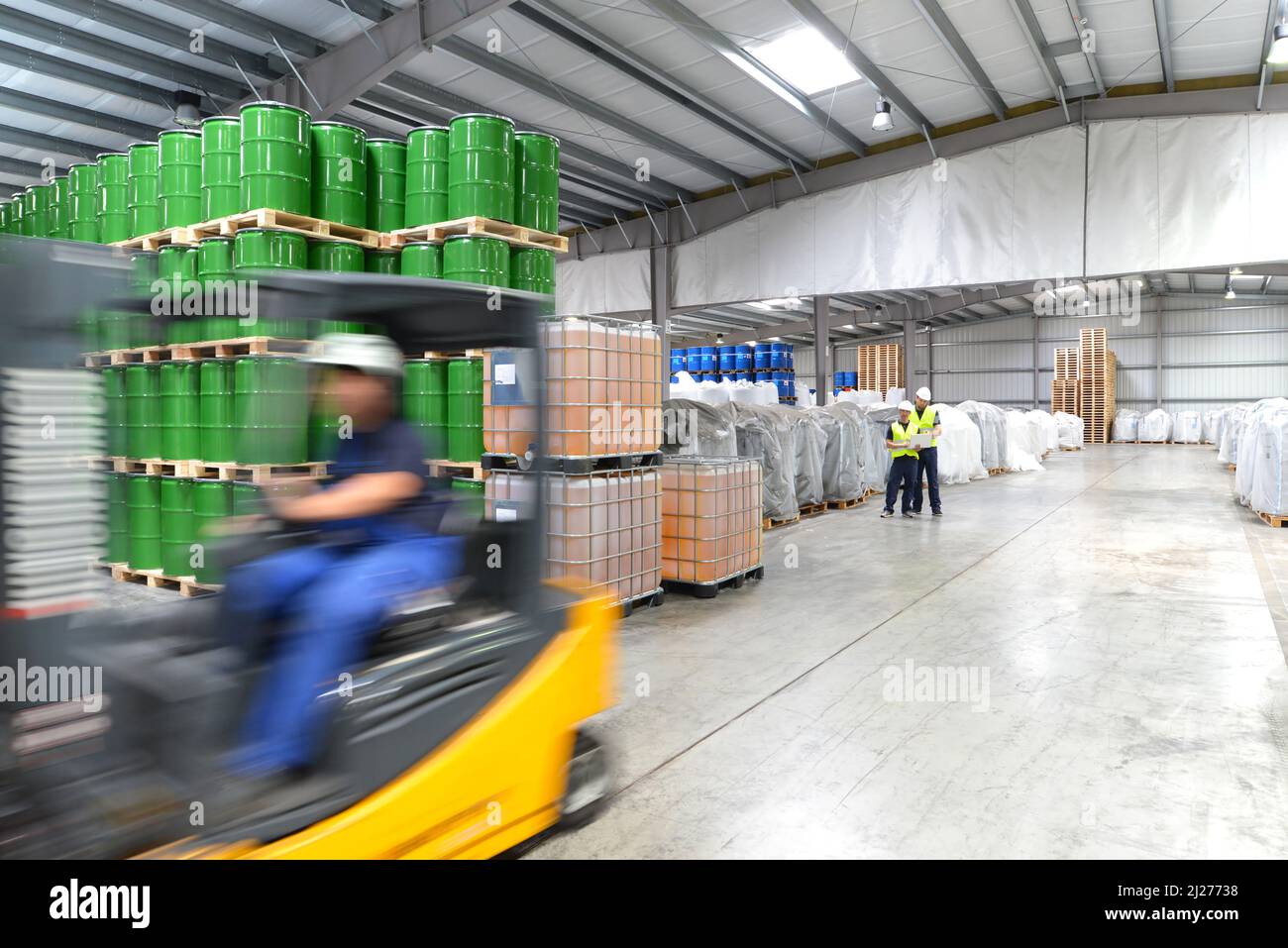 group of workers in the logistics industry work in a warehouse with chemicals Stock Photo