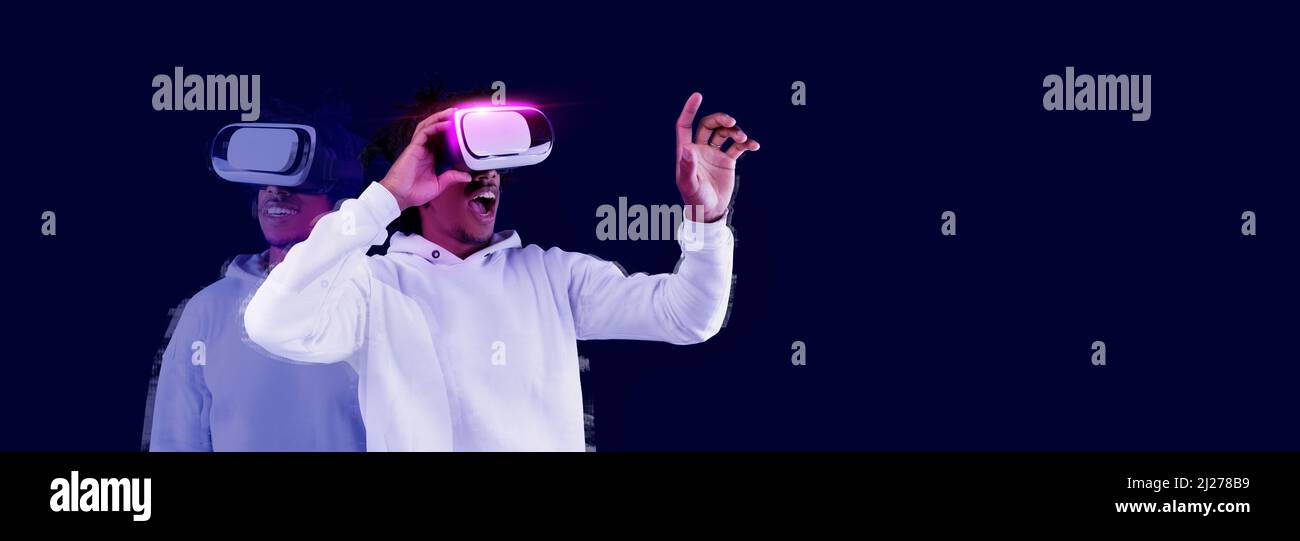 Excited young African American guy using VR glasses Stock Photo - Alamy