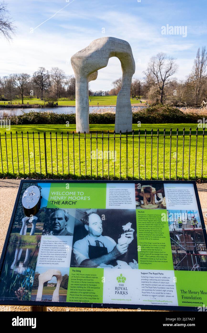 Henry Moore's sculpture, The Arch, with an information board, situated beside the Serpentine in Hyde Park, London, on a bright sunny winter's day. Stock Photo