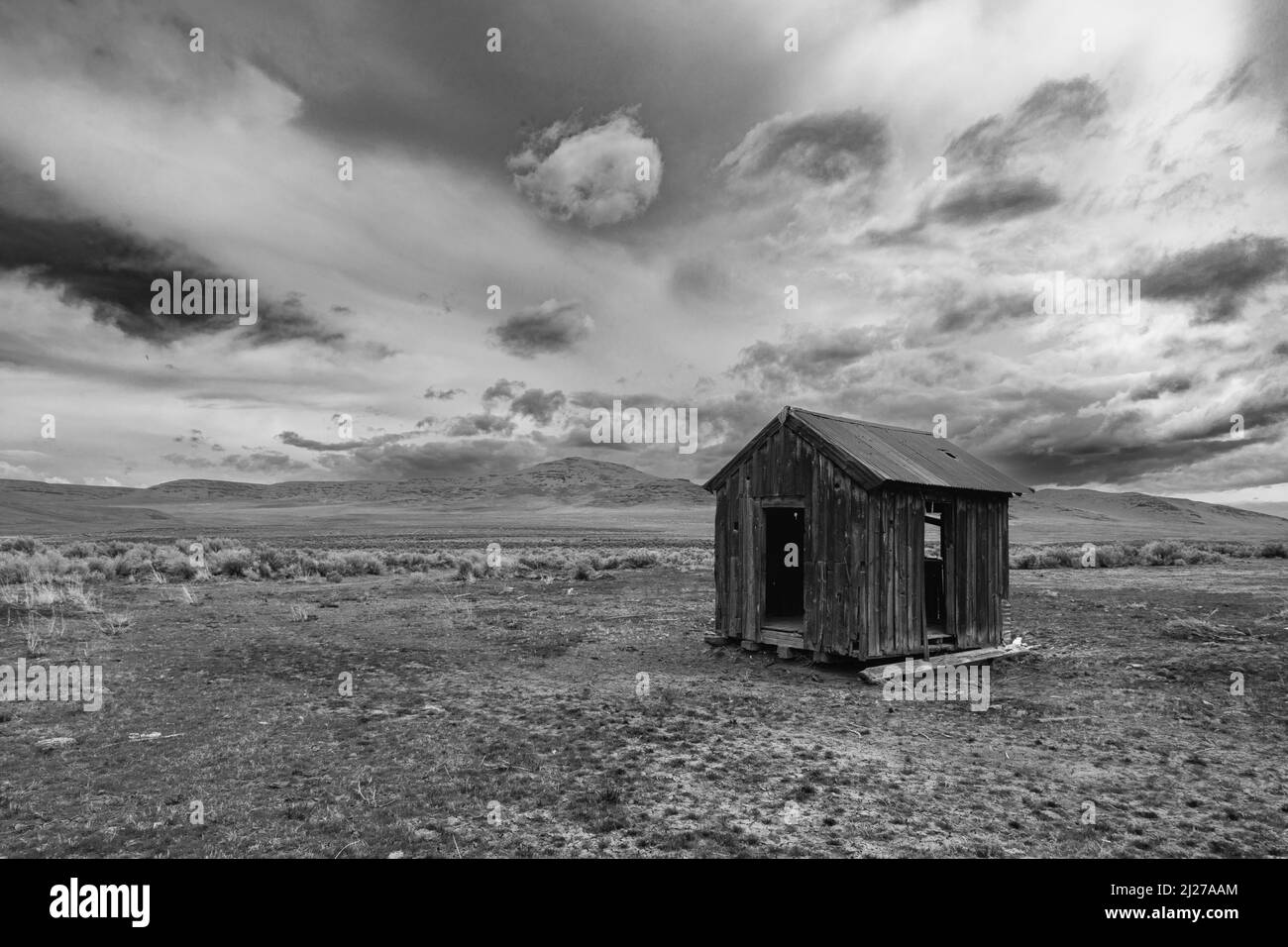 Small abandoned shack in the desert (monochrome).  Photographed in the high desert of Lassen County, California, USA. Stock Photo