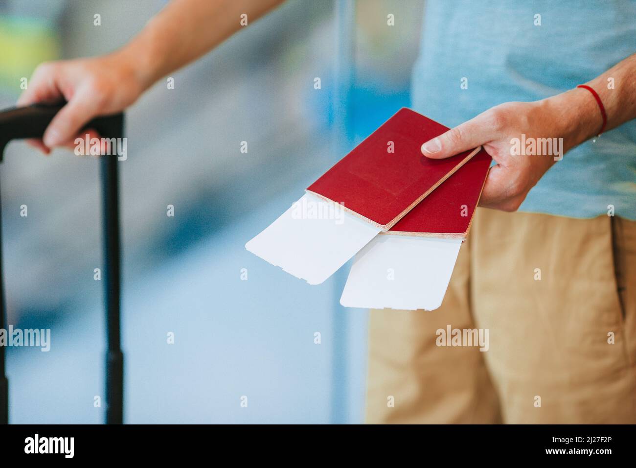 Passports and boarding pass in male hands at airport Stock Photo - Alamy
