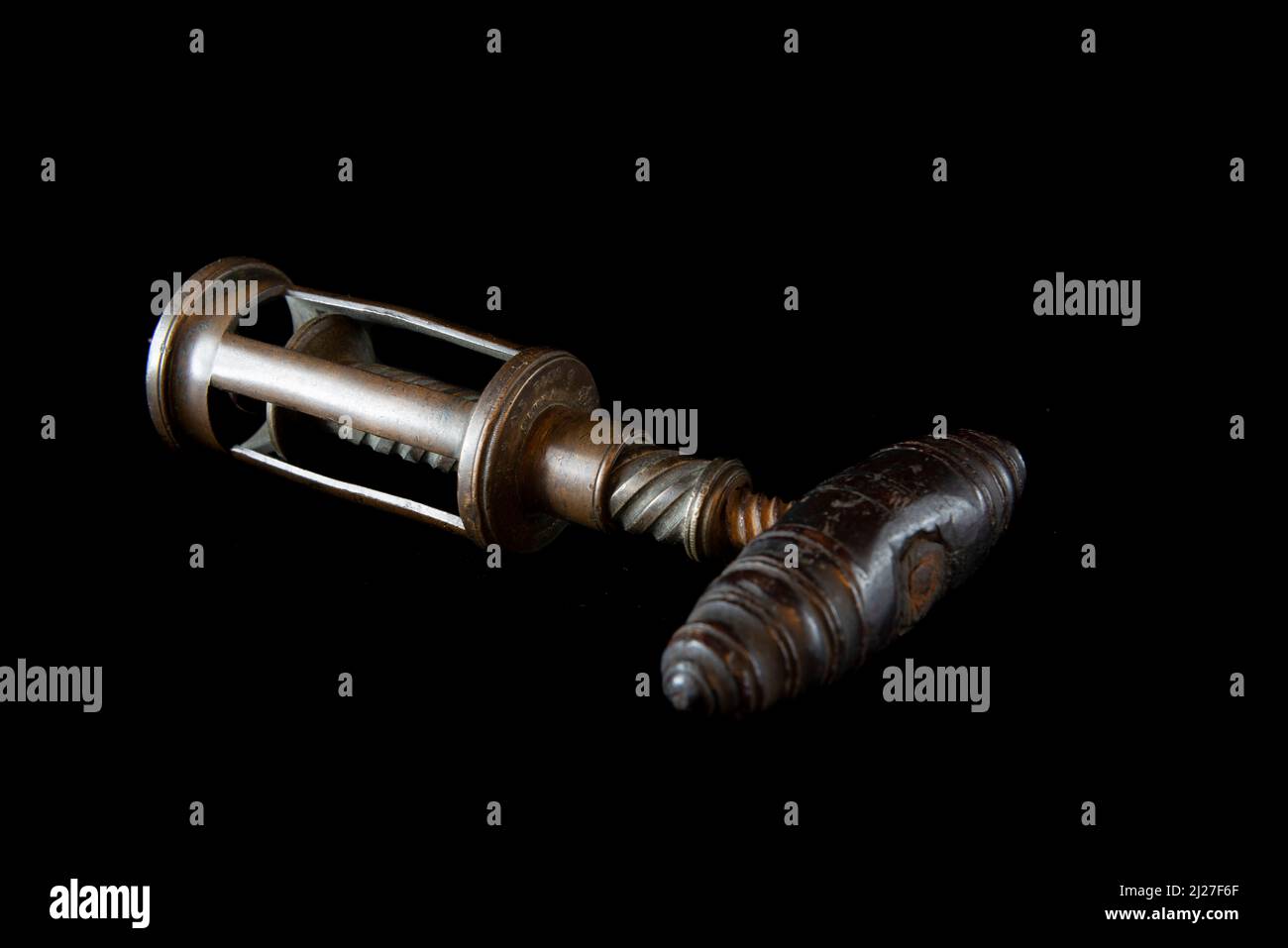 Antique vintage corkscrew on black background Stock Photo - Alamy