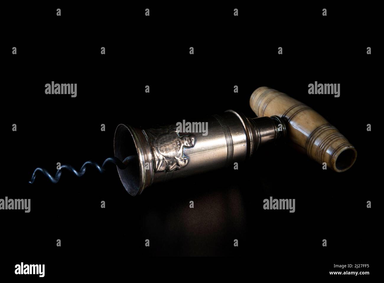 Antique vintage corkscrew on black background Stock Photo - Alamy