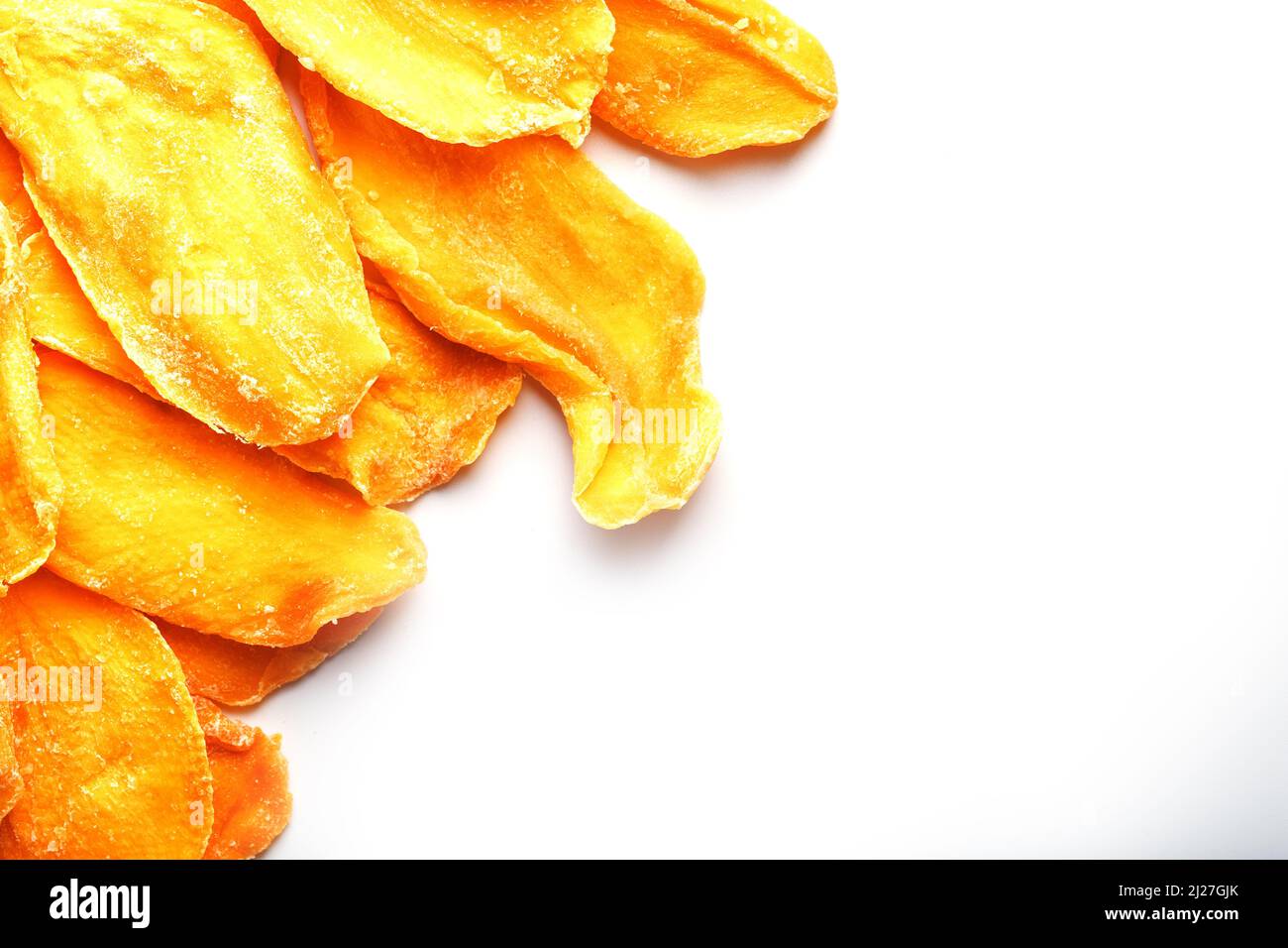Dried mango sliced on a white background with free space Stock Photo