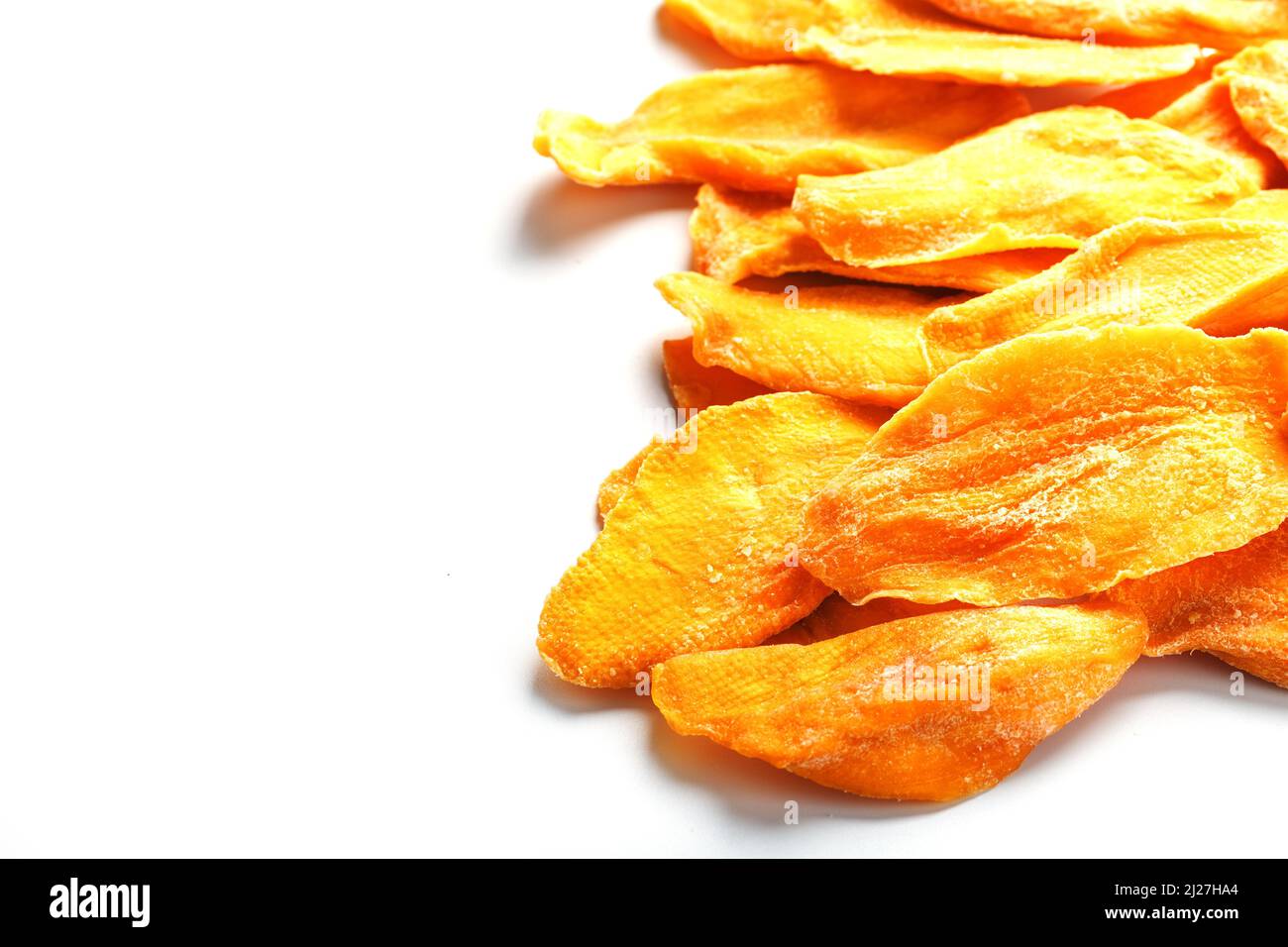 Dried mango sliced on a white background with free space Stock Photo