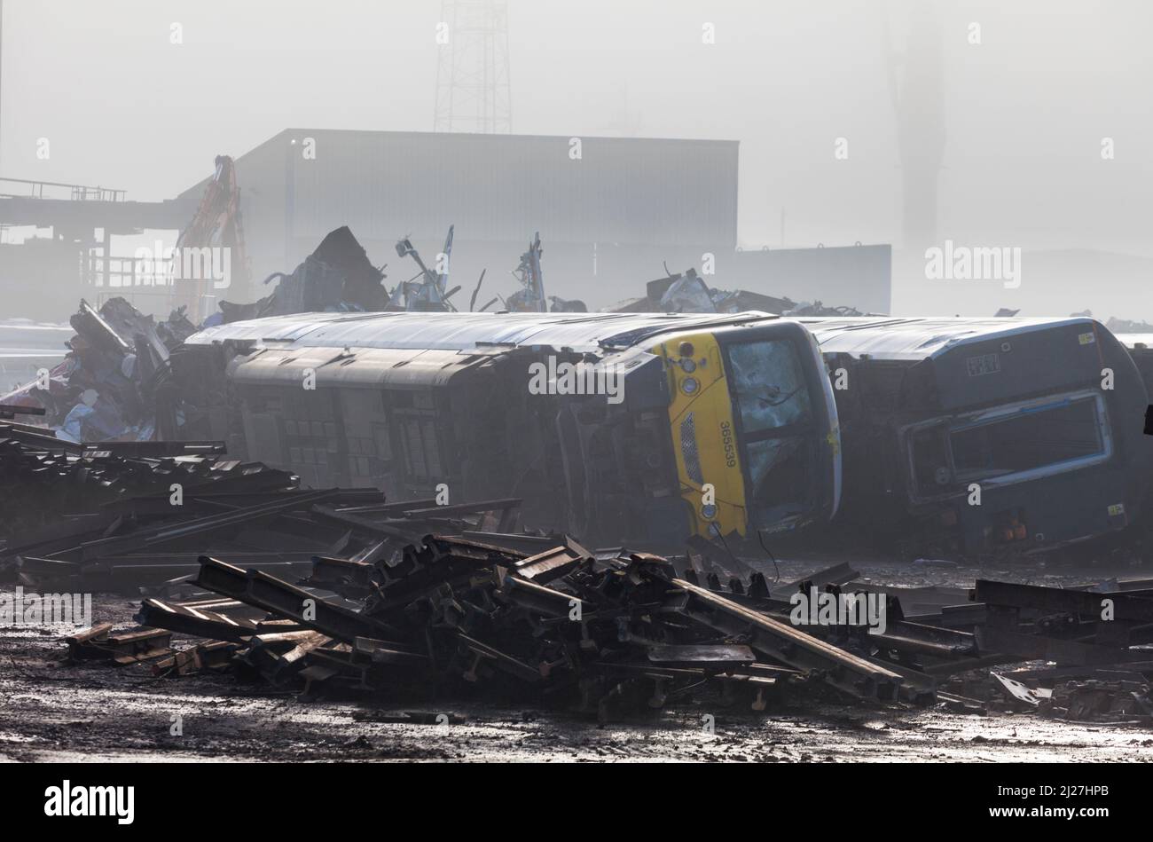 Withdrawn class 365 electric commuter trains on their sides waiting to be cut up for scrap at SIMS metals, Newport docks total destruction order. Stock Photo