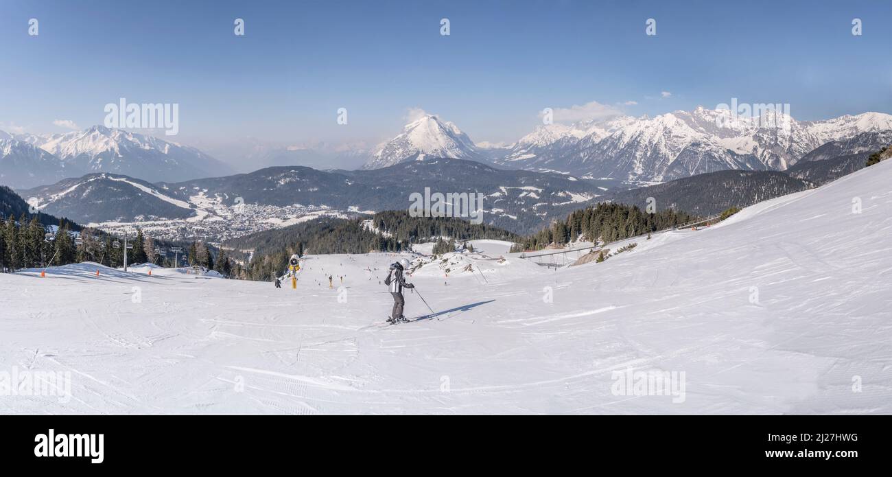 aerial winter mountain landscape with very large ski run  at Rosshutte, shot from above in bright light at Seefeld, Tyrol, Austria, Stock Photo