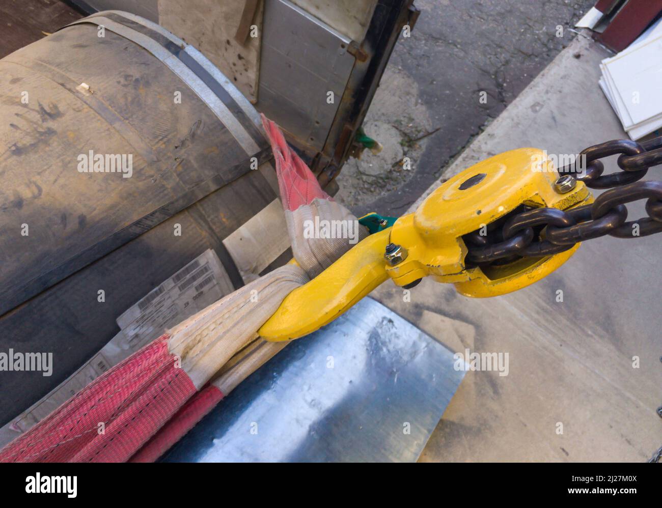 Lifting a coil of metal using a winch Stock Photo