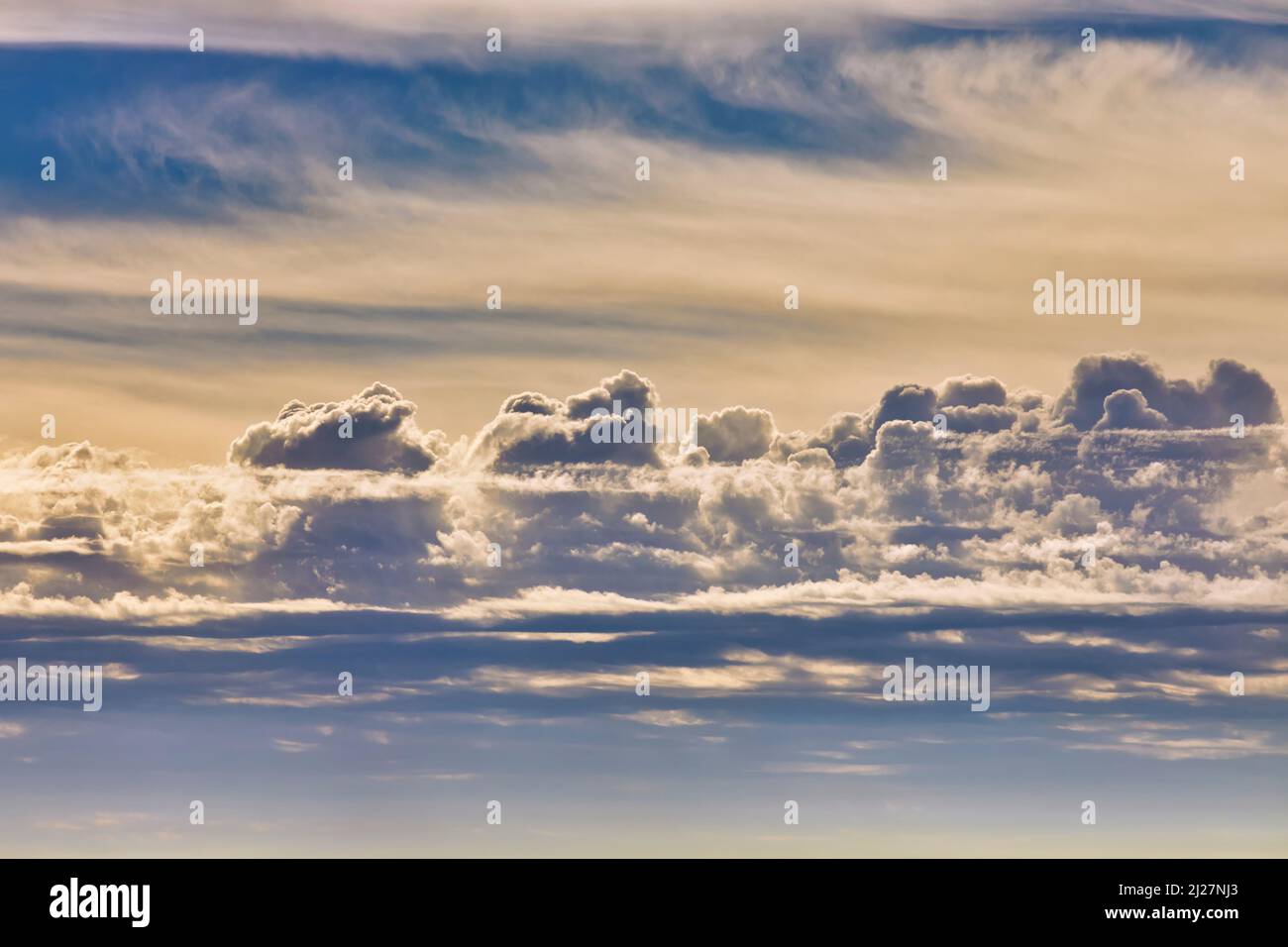 Cloudscape with Cumulus cloud in middle of picture and Cirrus cloud at top. Stock Photo