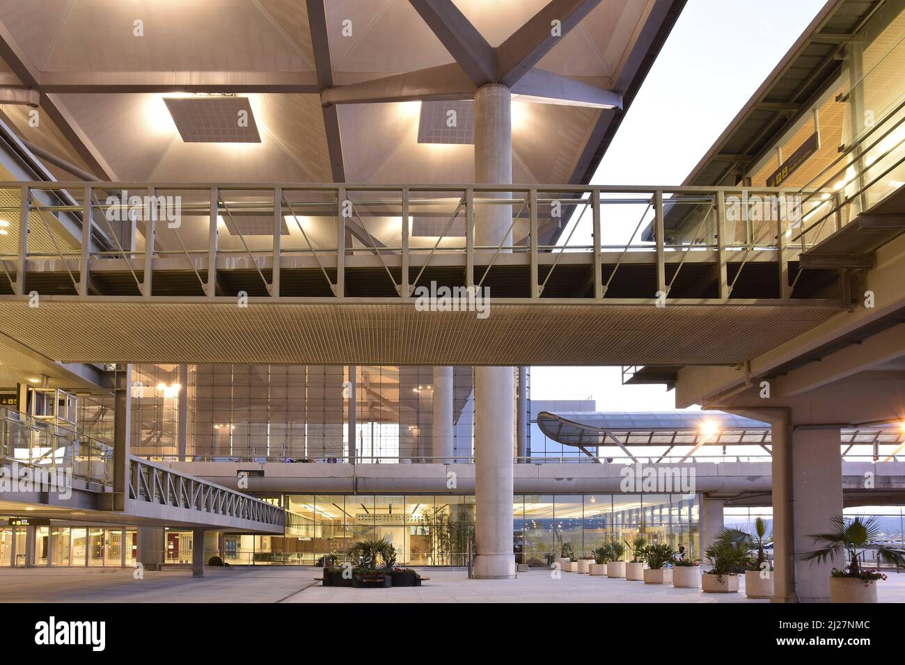 Costa del Sol airport, elevated walkways and modern Terminal T3 glass building at dusk in Malaga Andalusia Spain. Stock Photo