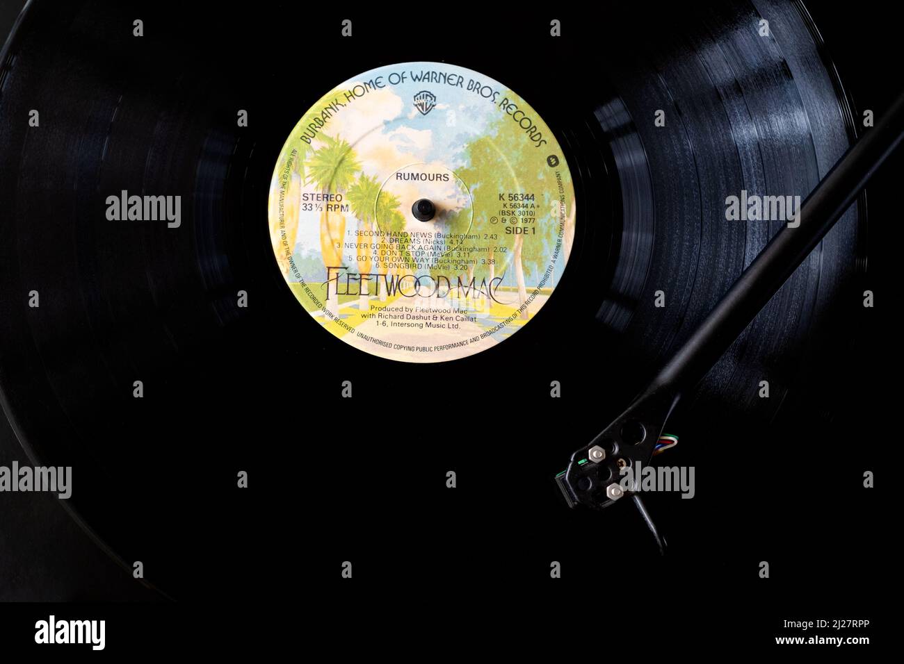 An overhead view of Fleetwood Macs vinyl LP Rumours. The record is shown on a record player or record deck with the needle moves across the record Stock Photo