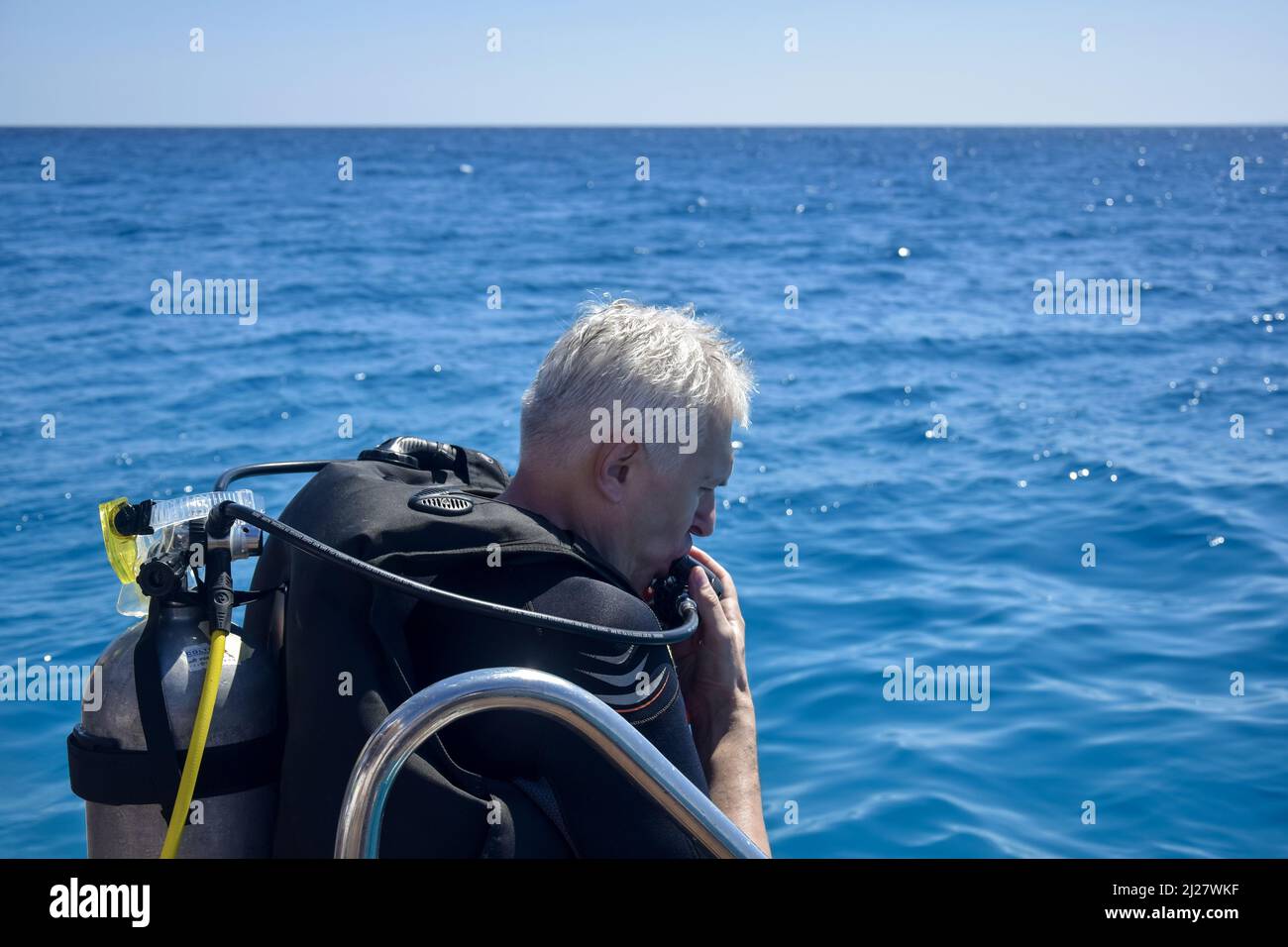 Scuba diver before diving. Diving lesson in open water. Male in scuba