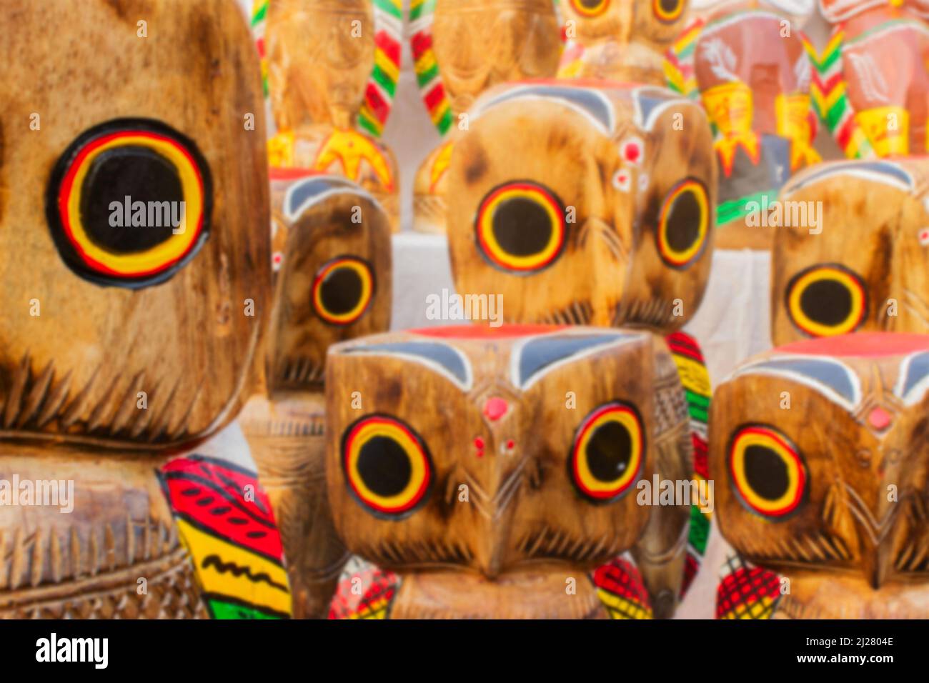 Blurred image of wooden owls, artworks of handicraft, on display during Handicraft Fair in Kolkata - the biggest handicrafts fair in Asia. Stock Photo