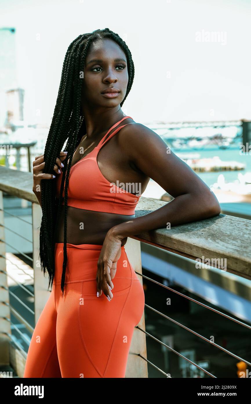 Beautiful young woman runner outdoor in sport outfit stretching