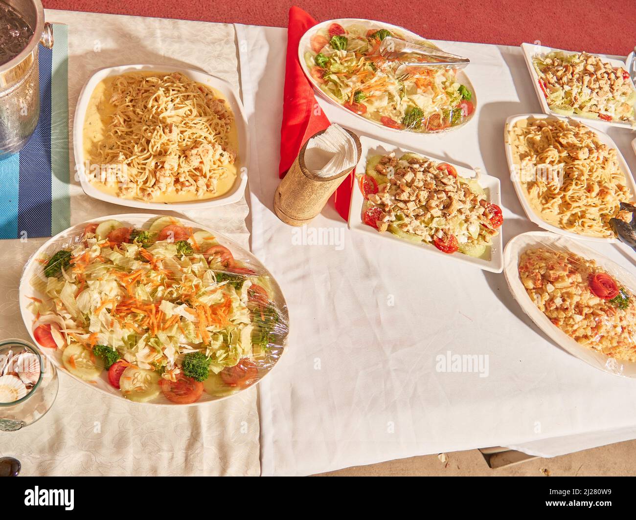 Gourmet wedding dinner on the beach eating tasty pastas and meats Stock