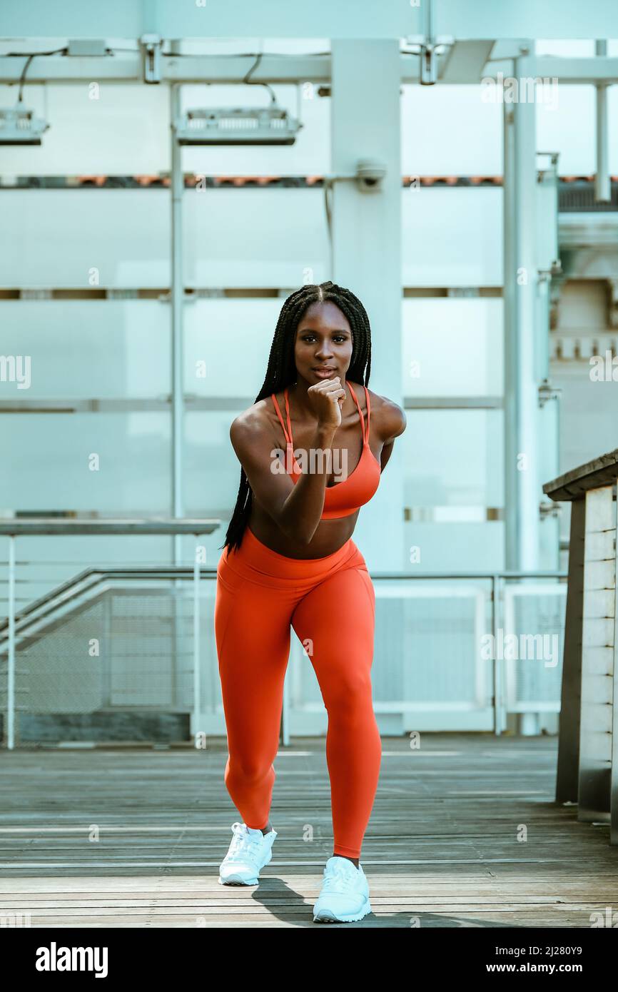 Beautiful young woman runner outdoor in sport outfit stretching