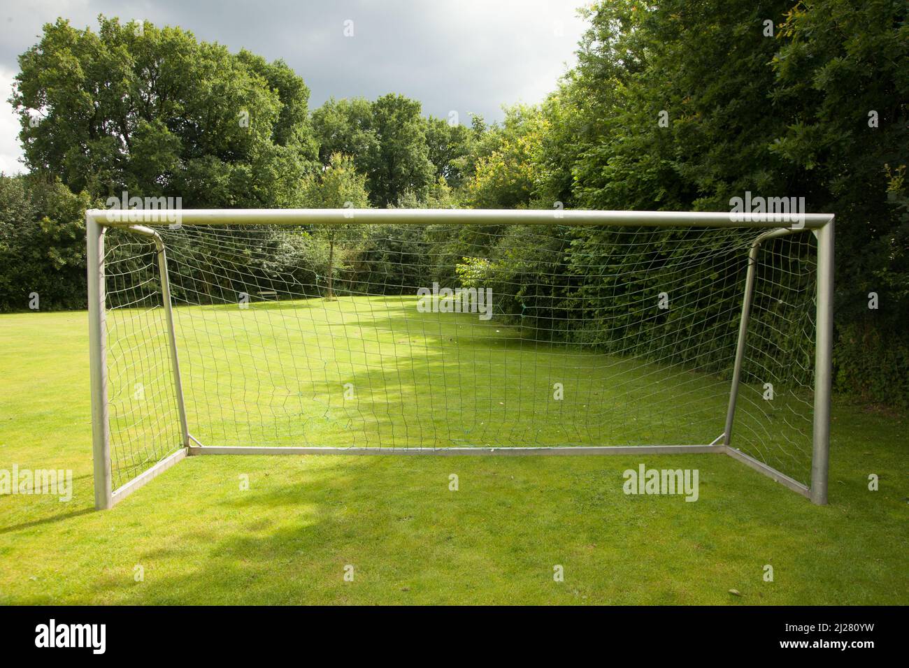 A soccer net in a sunny field Stock Photo Alamy
