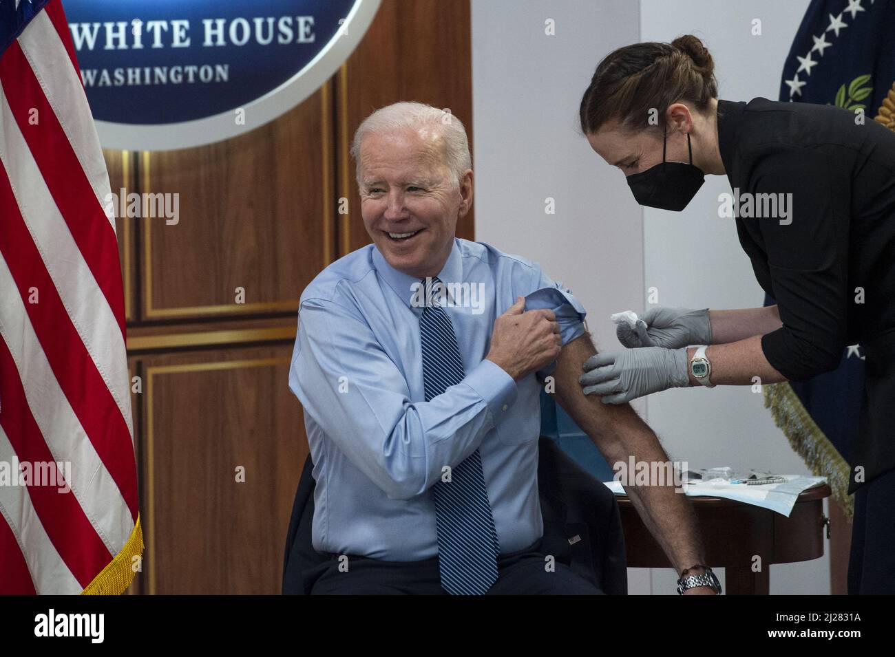 Washington, United States. 30th Mar, 2022. United States President Joe Biden receives his second COVID booster shot from Pfizer, by a member of the White House Medical Unit, following his remarks on the status of the country's fight against COVID-19, in the South Court Auditorium of the Eisenhower Executive Office Building on the White House campus in Washington, DC, Wednesday, March 30, 2022. Photo by Rod Lamkey/UPI Credit: UPI/Alamy Live News Stock Photo