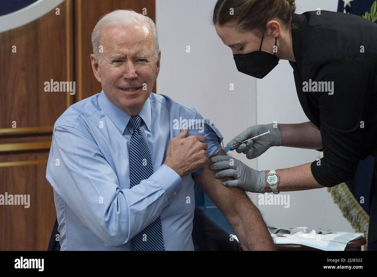 Washington, United States. 30th Mar, 2022. United States President Joe Biden receives his second COVID booster shot from Pfizer, by a member of the White House Medical Unit, following his remarks on the status of the country's fight against COVID-19, in the South Court Auditorium of the Eisenhower Executive Office Building on the White House campus in Washington, DC, Wednesday, March 30, 2022. Photo by Rod Lamkey/UPI Credit: UPI/Alamy Live News Stock Photo