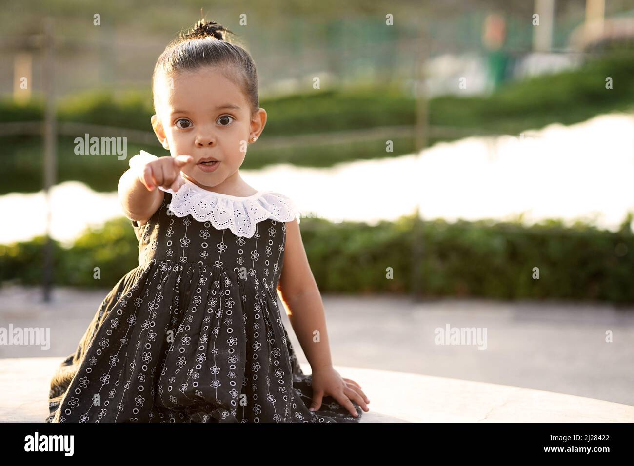 calm happy little girl enjoying a great beautiful day in the park outdoors 2J28422