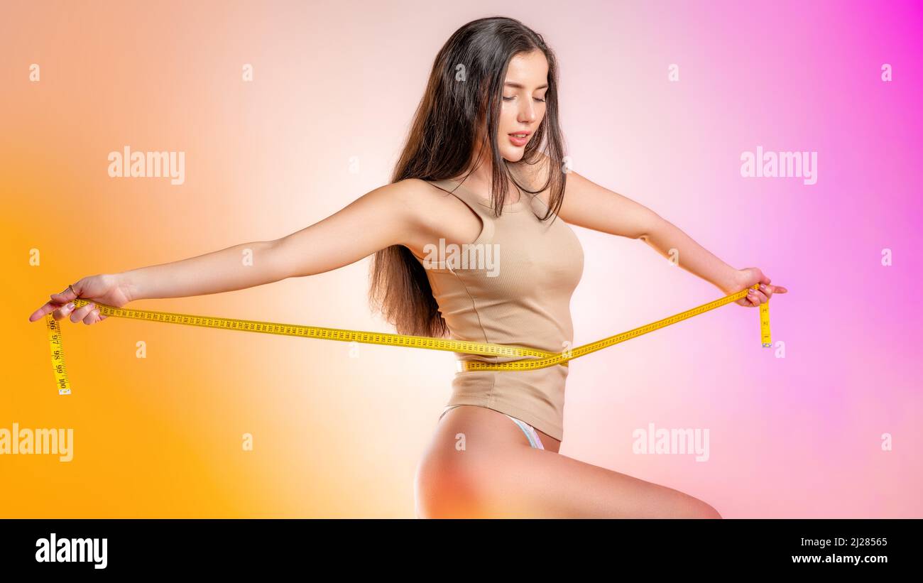 happy young woman with a measurement tape Stock Photo