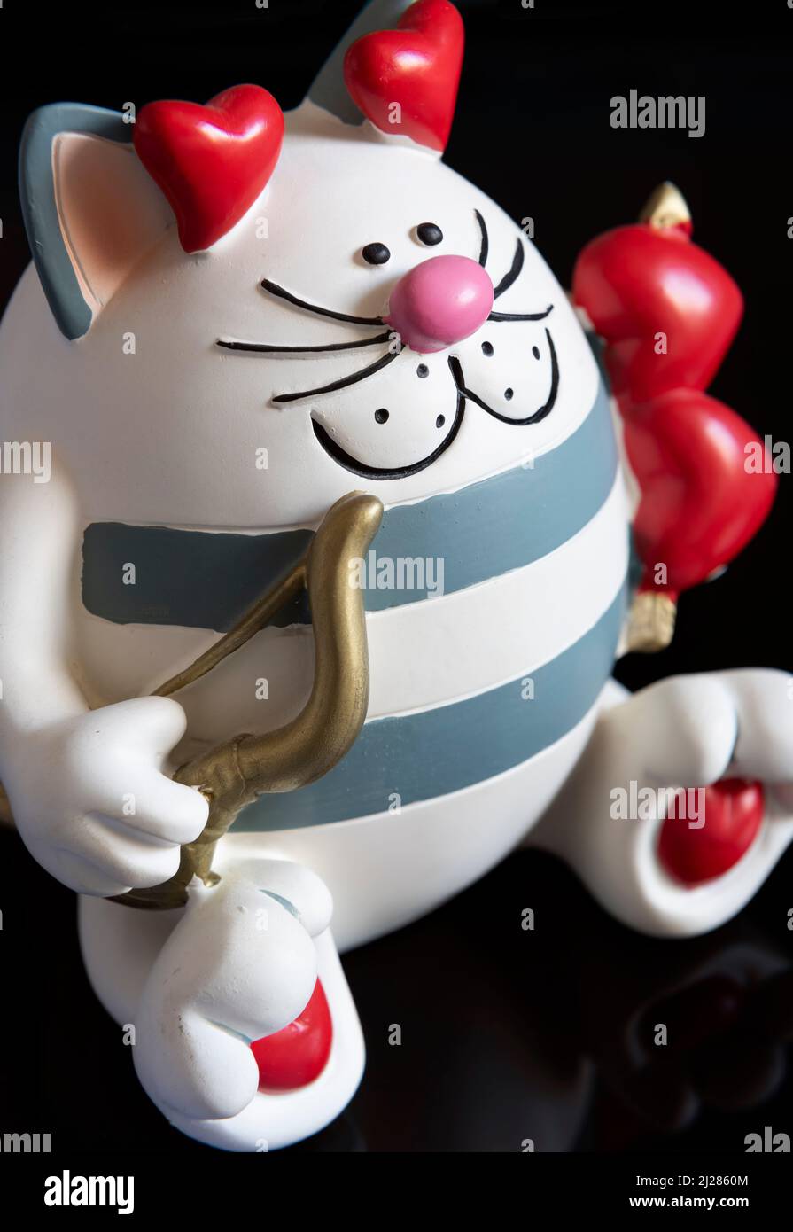 A novelty money box in the form of a caricature cupid cat. Stock Photo