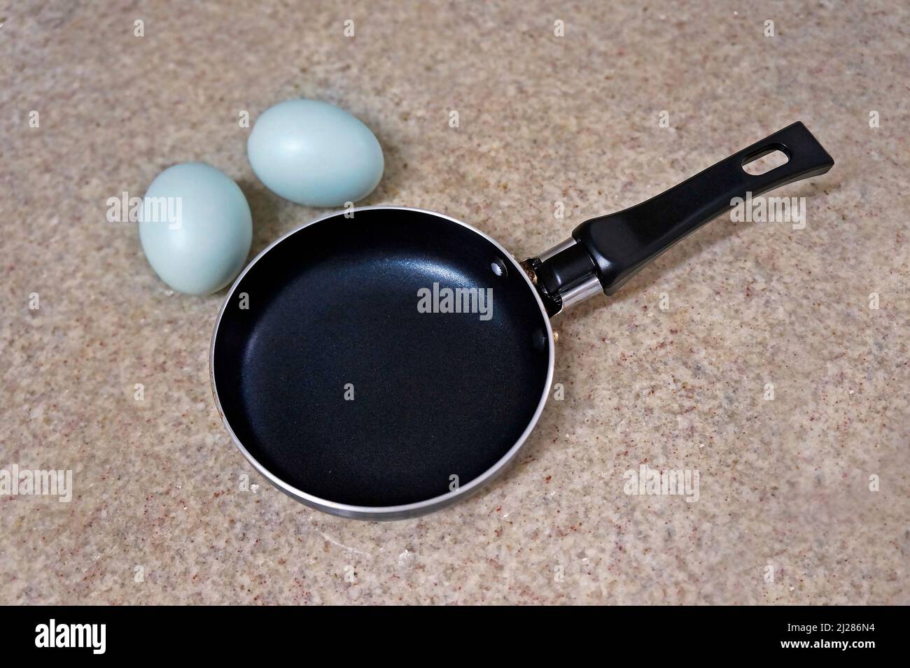 Mini frying pan and two blue chicken eggs Stock Photo