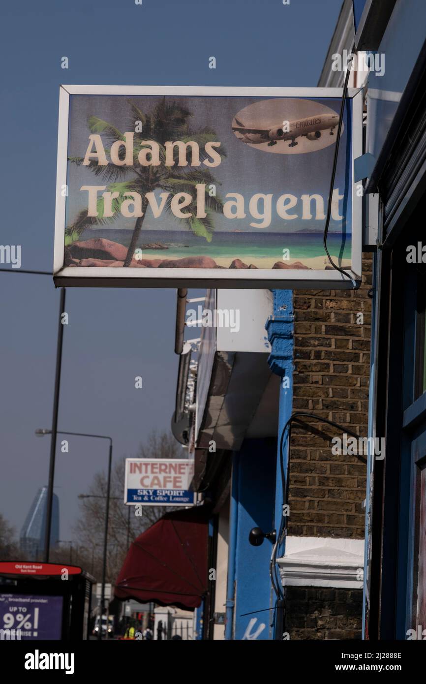 Travel agent on the Old Kent Road on 24th March 2022 in London, United Kingdom. Old Kent Road is a major thoroughfare in South East London passing through the Borough of Southwark. It was originally part of an ancient trackway that was paved by the Romans. It is now part of the A2, a major road from London to the South East coast. Nowadays the surroundings have a run down feel, and while there are many new housing developments, it has a very strong old East End atmosphere, with the more modern twist of a very multicultural population. Stock Photo