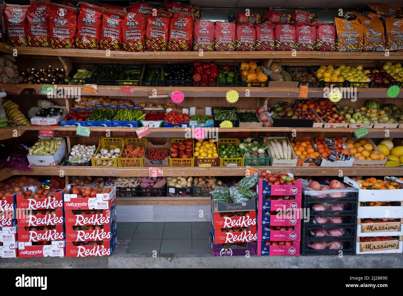 Fruit and vegetable shop on the Old Kent Road on 24th March 2022 in London, United Kingdom. Old Kent Road is a major thoroughfare in South East London passing through the Borough of Southwark. It was originally part of an ancient trackway that was paved by the Romans. It is now part of the A2, a major road from London to the South East coast. Nowadays the surroundings have a run down feel, and while there are many new housing developments, it has a very strong old East End atmosphere, with the more modern twist of a very multicultural population. Stock Photo