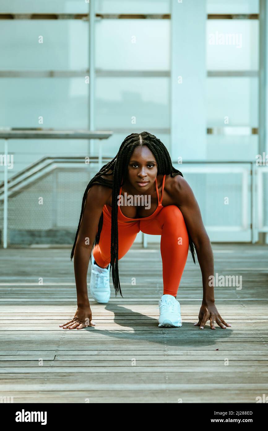 Beautiful young woman runner outdoor in sport outfit stretching personal  trainer sports gym Stock Photo - Alamy