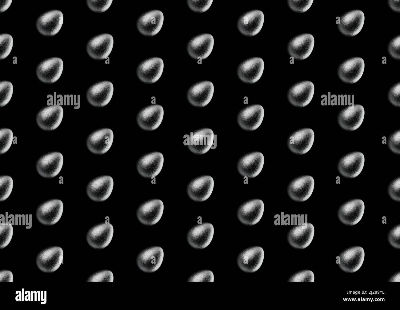 Chocolate easter egg pattern with silver Aluminium foil on black background. Wallpaper. backdrop. Stock Photo