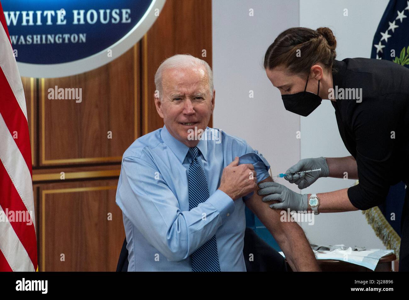 United States President Joe Biden receives his second COVID booster shot from Pfizer, by a member of the White House Medical Unit, following his remarks on the status of the countryâs fight against COVID-19, in the South Court Auditorium of the Eisenhower Executive Office Building on the White House campus in Washington, DC, Wednesday, March 30, 2022. Credit: Rod Lamkey/Pool via CNP Stock Photo