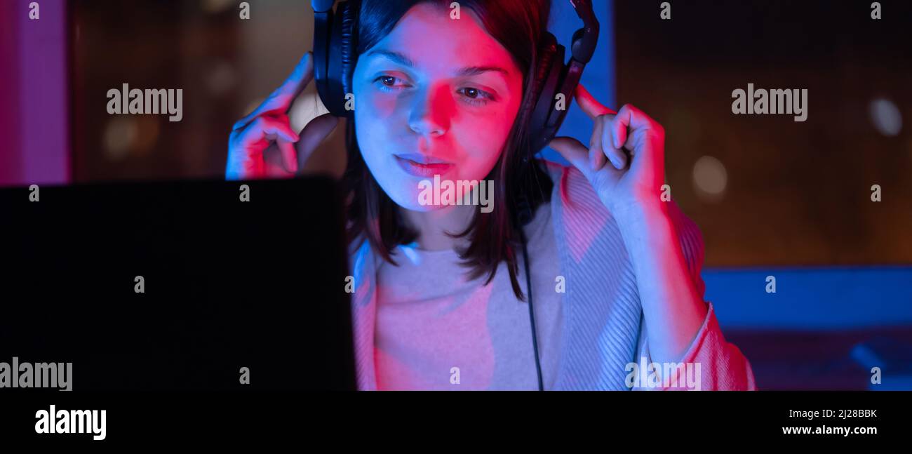 Girl is listening music at home at night. Stock Photo