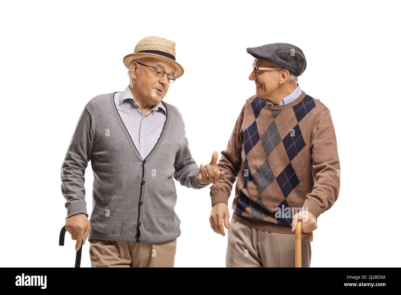 Elderly men with walking canes talking isolated on white background Stock Photo