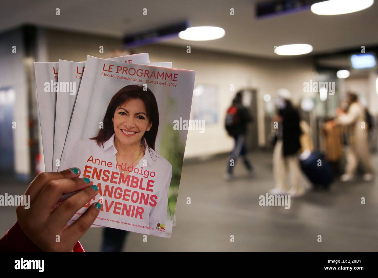 Nice, France. 29th Mar, 2022. A person holds Paris Mayor and Socialist Party candidate for the 2022 French presidential election Anne Hidalgo's leaflet at a railway station. The first round of the French Presidential Election 2022 will take place on Sunday 10th April 2022. (Photo by Dinendra Haria/SOPA Images/Sipa USA) Credit: Sipa USA/Alamy Live News Stock Photo