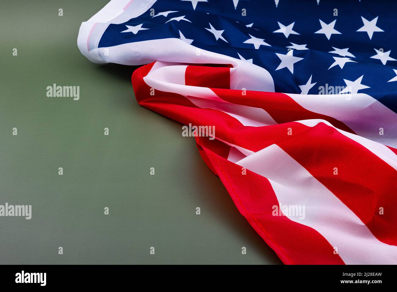 United States flag on a green background, a flag of the United States, against an olive green background with a blank on the left side Stock Photo