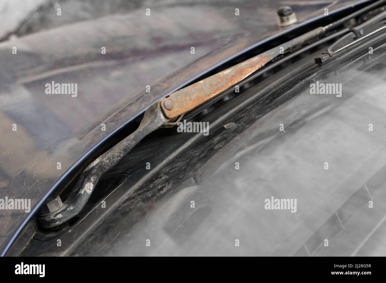 Old rusty non-working car windshield wipers, close-up, wear and tear of transport parts. Stock Photo