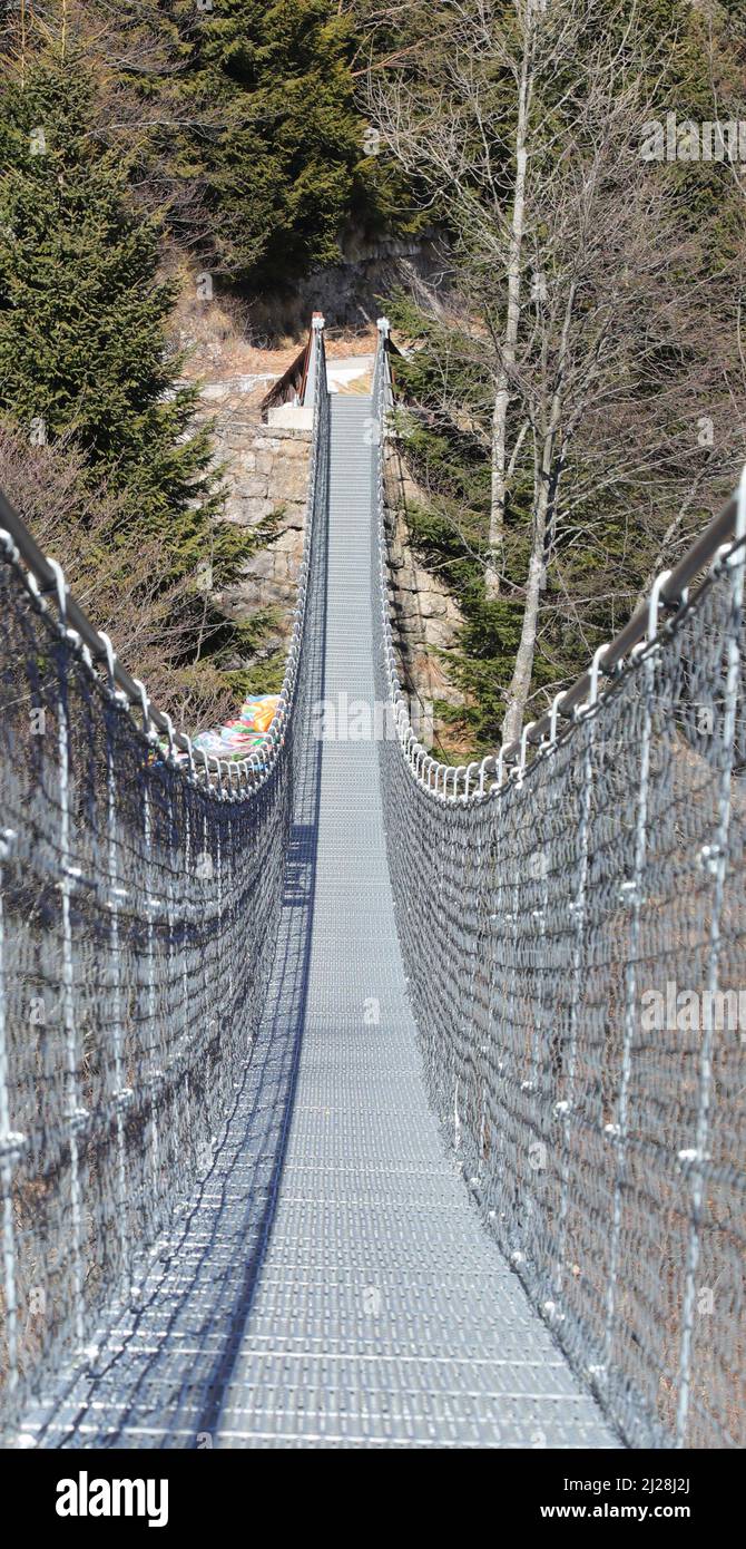 long suspension bridge made with sturdy steel cables to connect the two ridges of the mountain Stock Photo