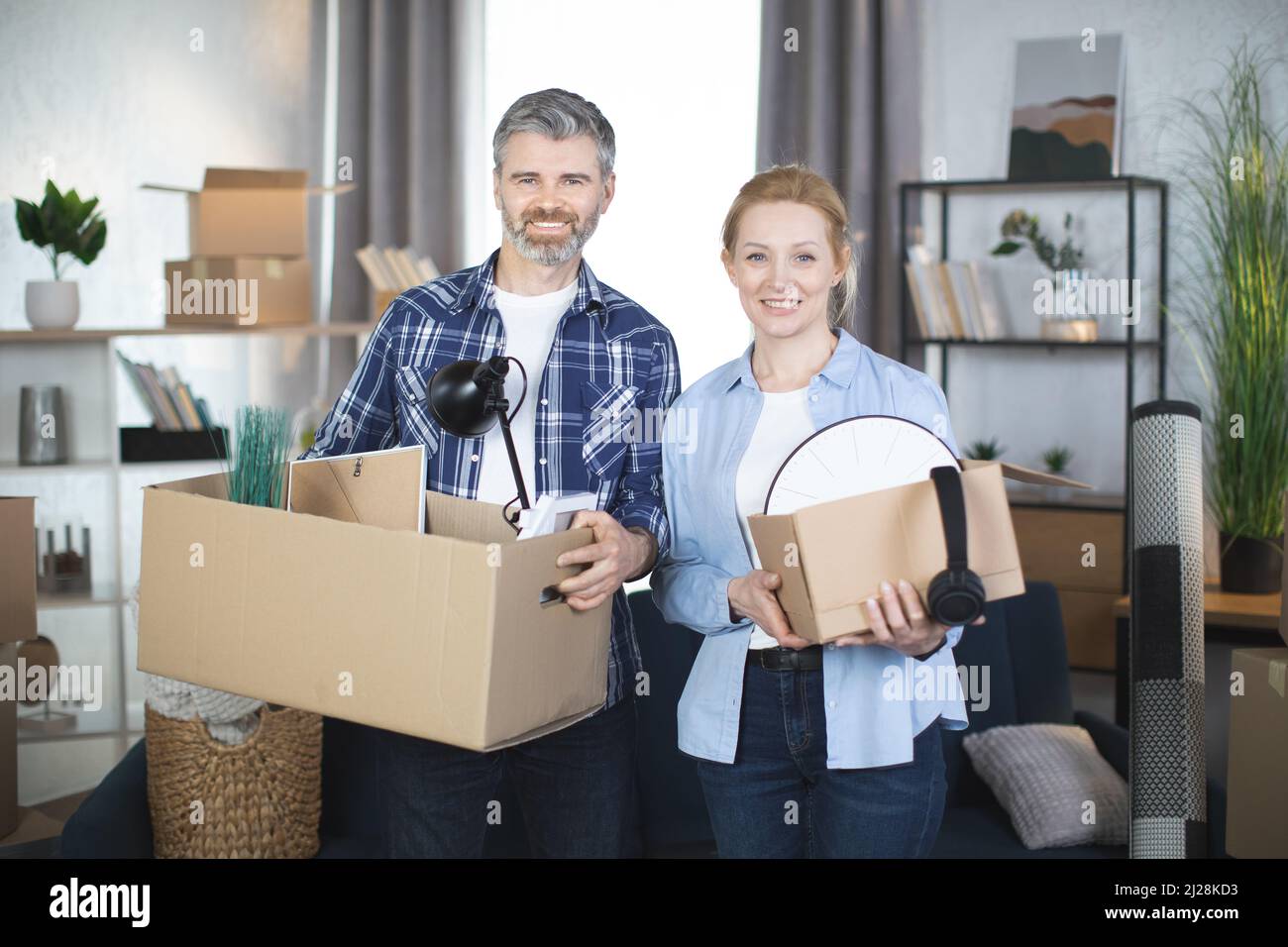 Hugging Boxes Young family boxes things hi-res stock photography and images - Alamy