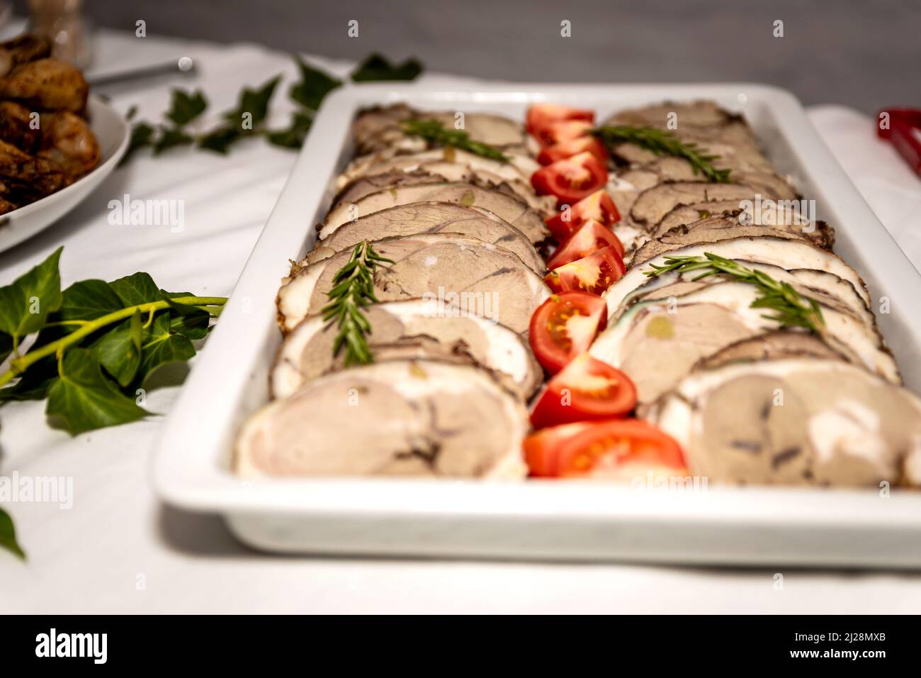 Roasted meat cold cut slices on a white platter Stock Photo