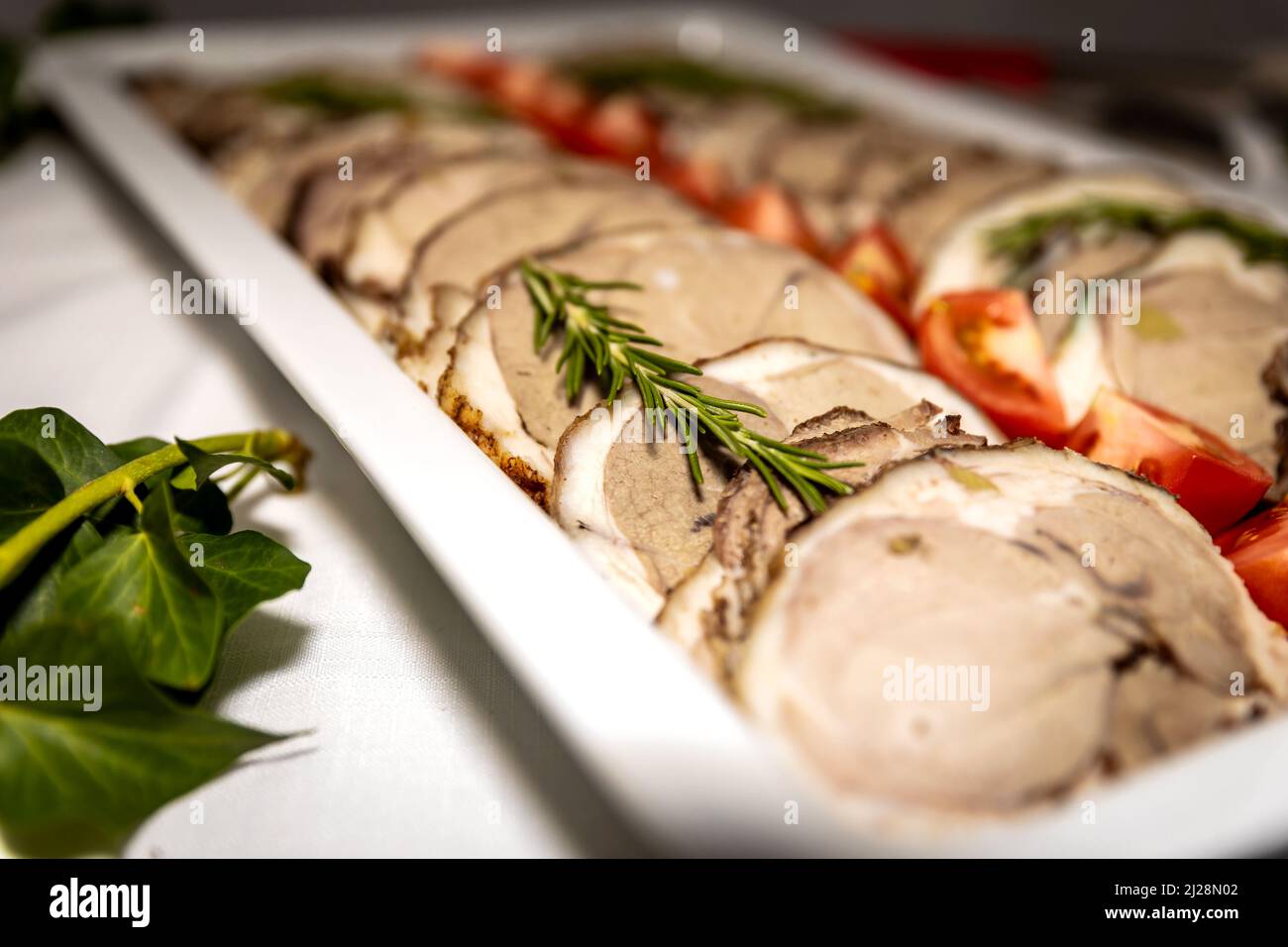 Roasted meat cold cut slices on a white platter Stock Photo Alamy