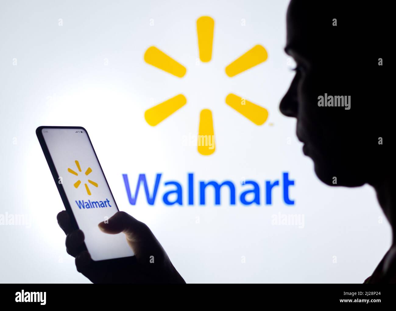 Brazil. 30th Mar, 2022. In this photo illustration, a woman's silhouette  holds a smartphone with the Walmart logo displayed on the screen and in the  background. Credit: SOPA Images Limited/Alamy Live News
