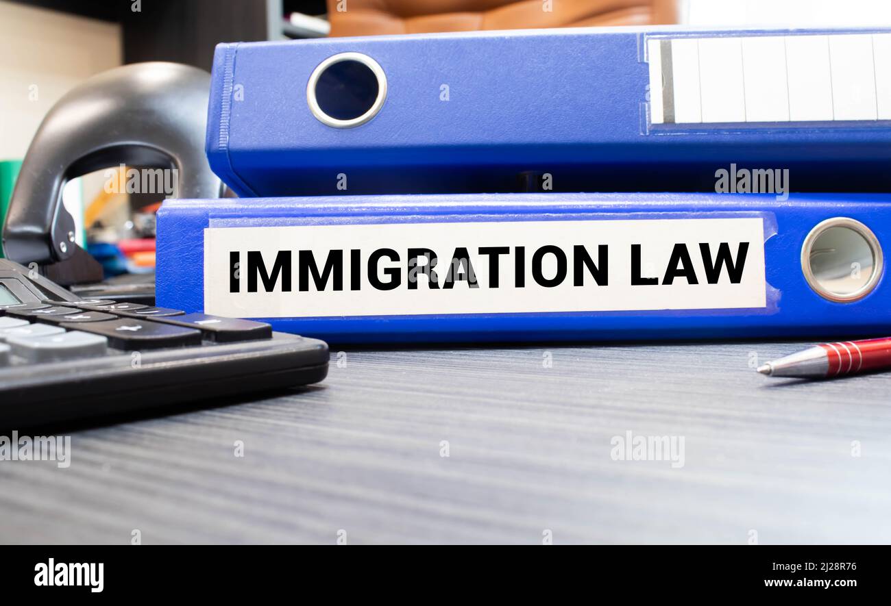 Blue folder with the label Immigration Law, concept Stock Photo - Alamy