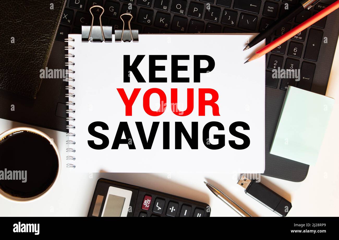 Yellow sticker with text Keep Your Savings laying on the folder with ...