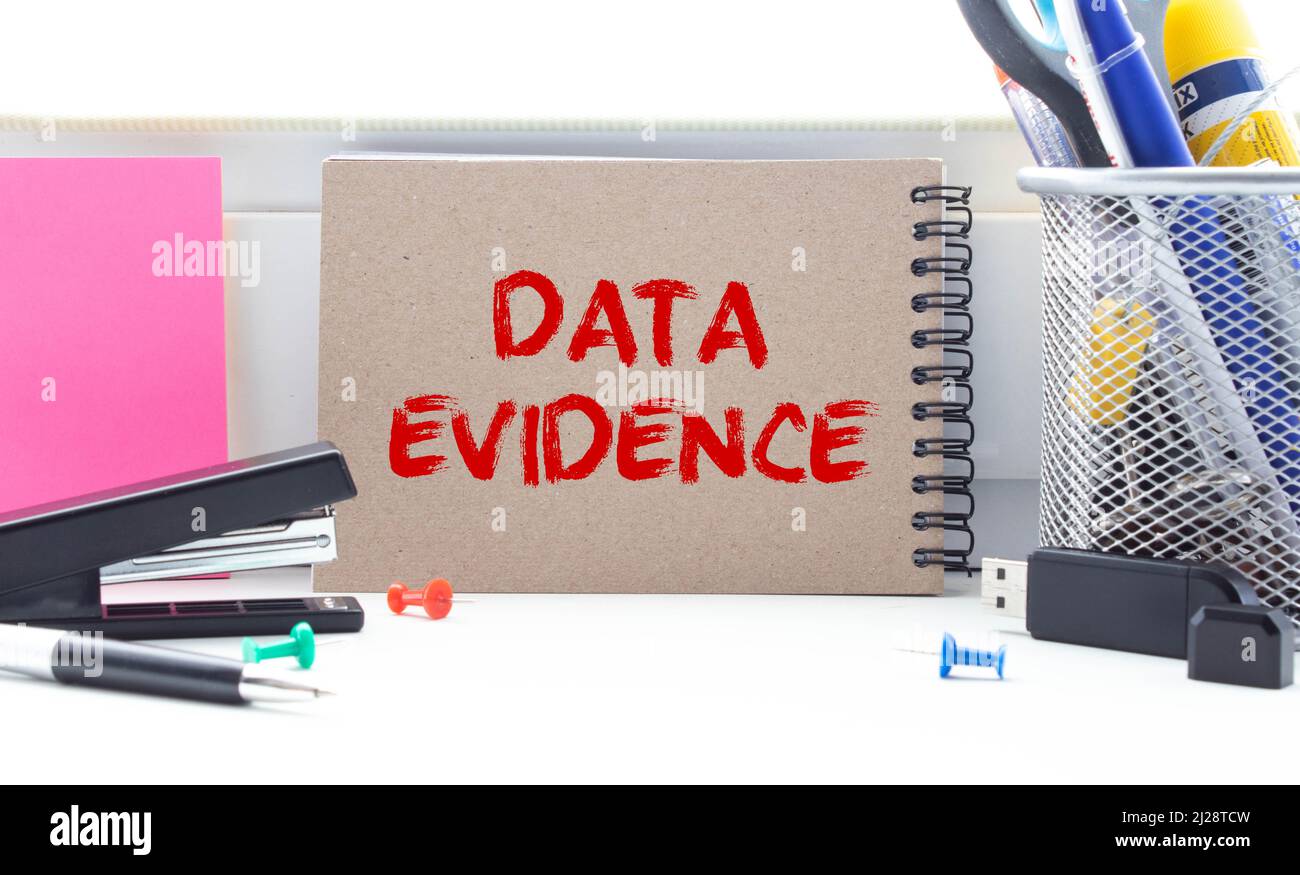DATA EVIDENCE - business concept, text on a notebook with a spring on a ...