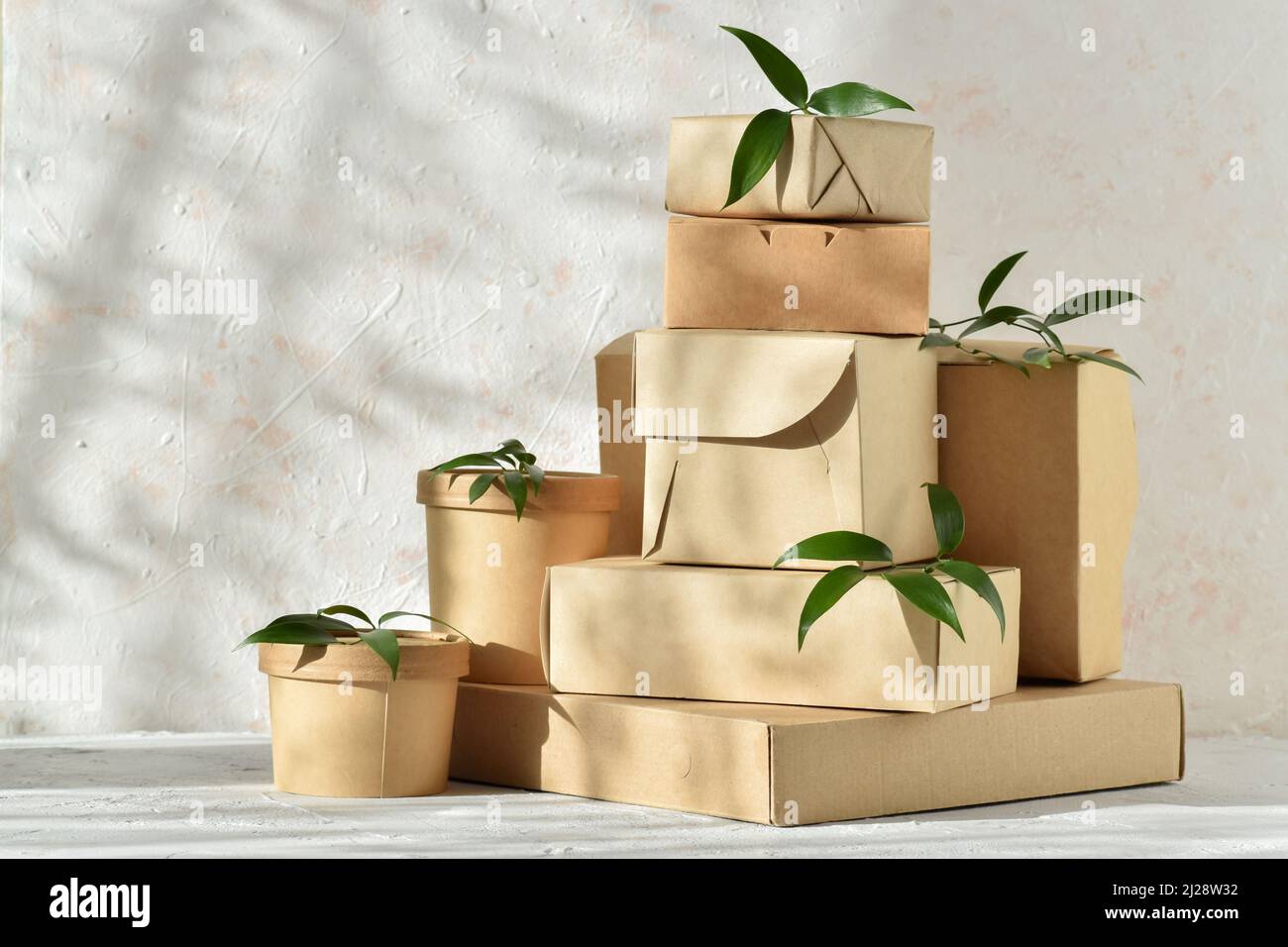 Eco packaging made of paper and cardboard. Takeaway food delivery. Various paper packages with natural light Stock Photo